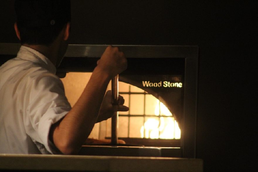 Fresh pizza is placed in the hot brick oven and baked to a crisp just like the pizzerias near you. 